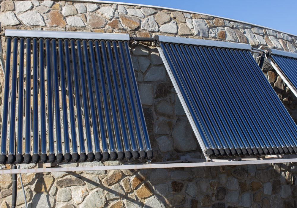 Solar water heating system installed on wall or roof of house.